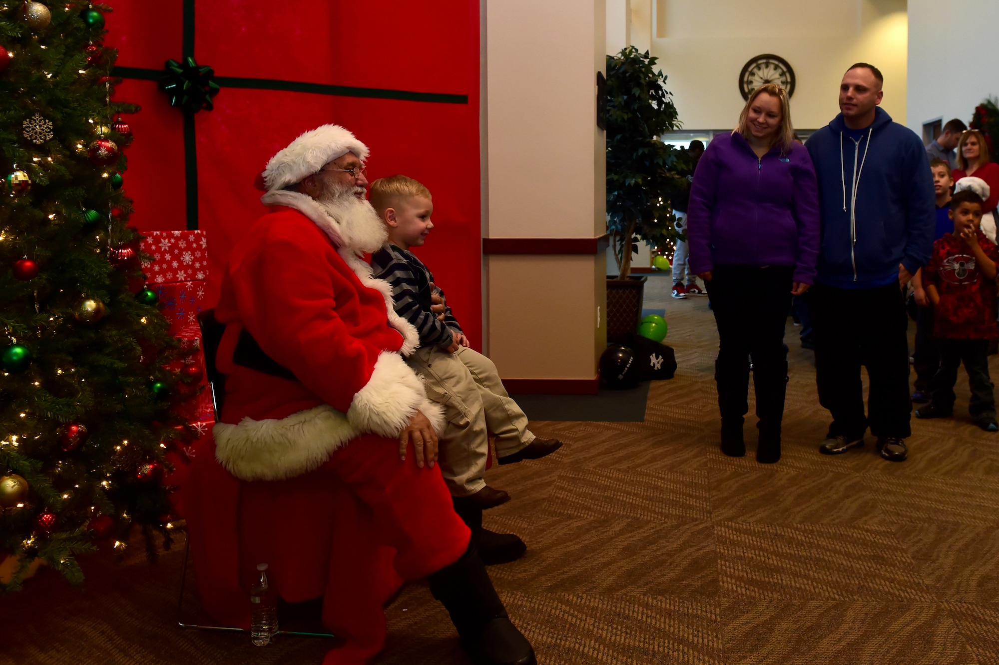 - A Team Buckley child gets his photo taken with Santa Claus during Breakfast with Santa at the Leadership Development Center Dec. 12, 2015, on Buckley Air Force Base, Colo. The event provided breakfast, a gift for each child and the opportunity for a picture with Santa Claus. (U.S. Air Force photo by Airman 1st Class Luke Nowakowski/Released)