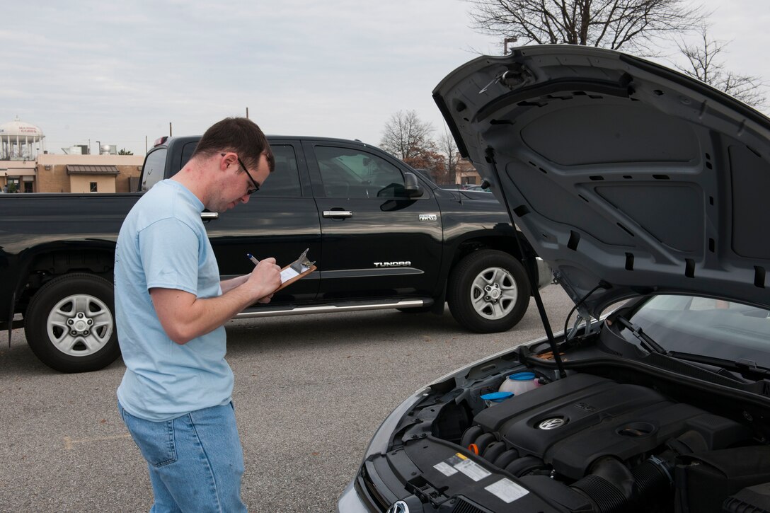 Staff Sgt. Zachariah Almon, 11th Logistics Readiness Squadron assistant NCO in-charge fire truck maintenance, completes a vehicle inspection checklist during a free winter vehicle inspection event at Joint Base Andrews, M.d., Dec. 12, 2015. Airmen from the 11th Logistics Readiness Squadron Vehicle Management Flight performed the inspections that included checking the tire pressure and tire wear, fluids, lights, windshield wipers and the serpentine belt condition. (U.S. Air Force photo by Senior Airman Dylan Nuckolls/Released)