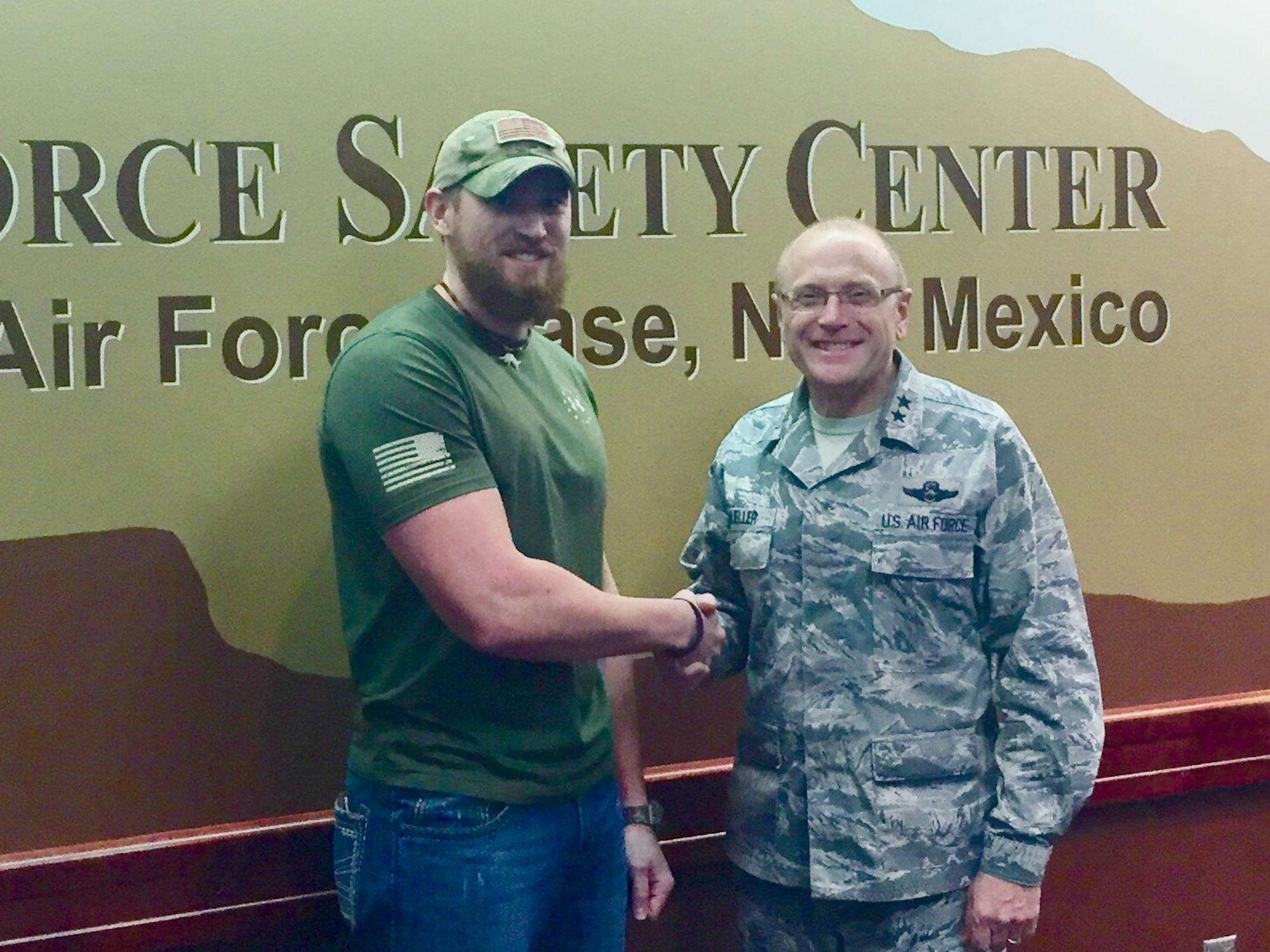 Jason Webb, 341st Missile Wing Safety Office occupational safety technician, left, is coined by Maj. Gen. Andrew Mueller, Air Force Chief of Safety, for his actions in helping a military member receive professional help during a time of need. Webb is currently attending a Mishap Investigation Non-Aviation course at the Air Force Safety Center based at Kirtland Air force Base, Albuquerque, N.M., where the event took place. (Courtesy photo) 
