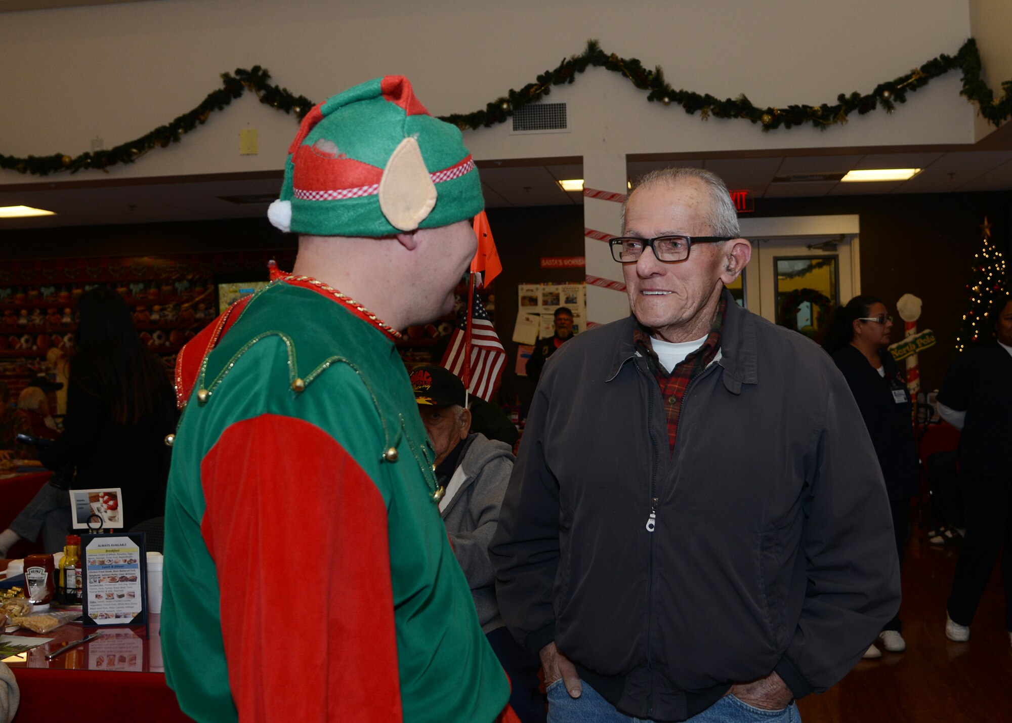 Tech. Sgt. Michael Burd, Air Force Association chapter president, talks to one of the residents at the Pete Knight Veteran’s Home during the first annual “Operation Bring Joy.” (U.S. Air Force photo by Rebecca Amber)
