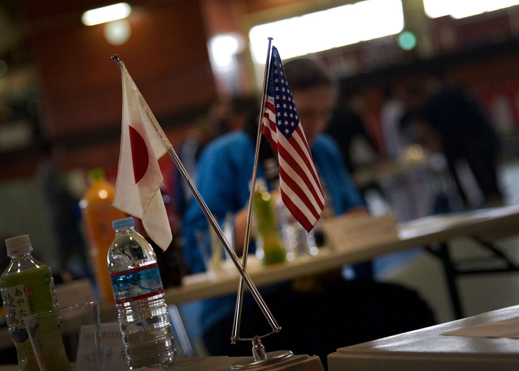 A Japanese and American flag sit on each tasting table during the annual Mochi Pounding Ceremony at Misawa Air Base, Japan, Dec. 15, 2015. The ceremony is held to celebrate teamwork and strong bonds between the 35th Fighter Wing, Japan Air Self-Defense Force and the Naval Air Facility Misawa. (U.S. Air Force photo by Senior Airman Deana Heitzman/Released)