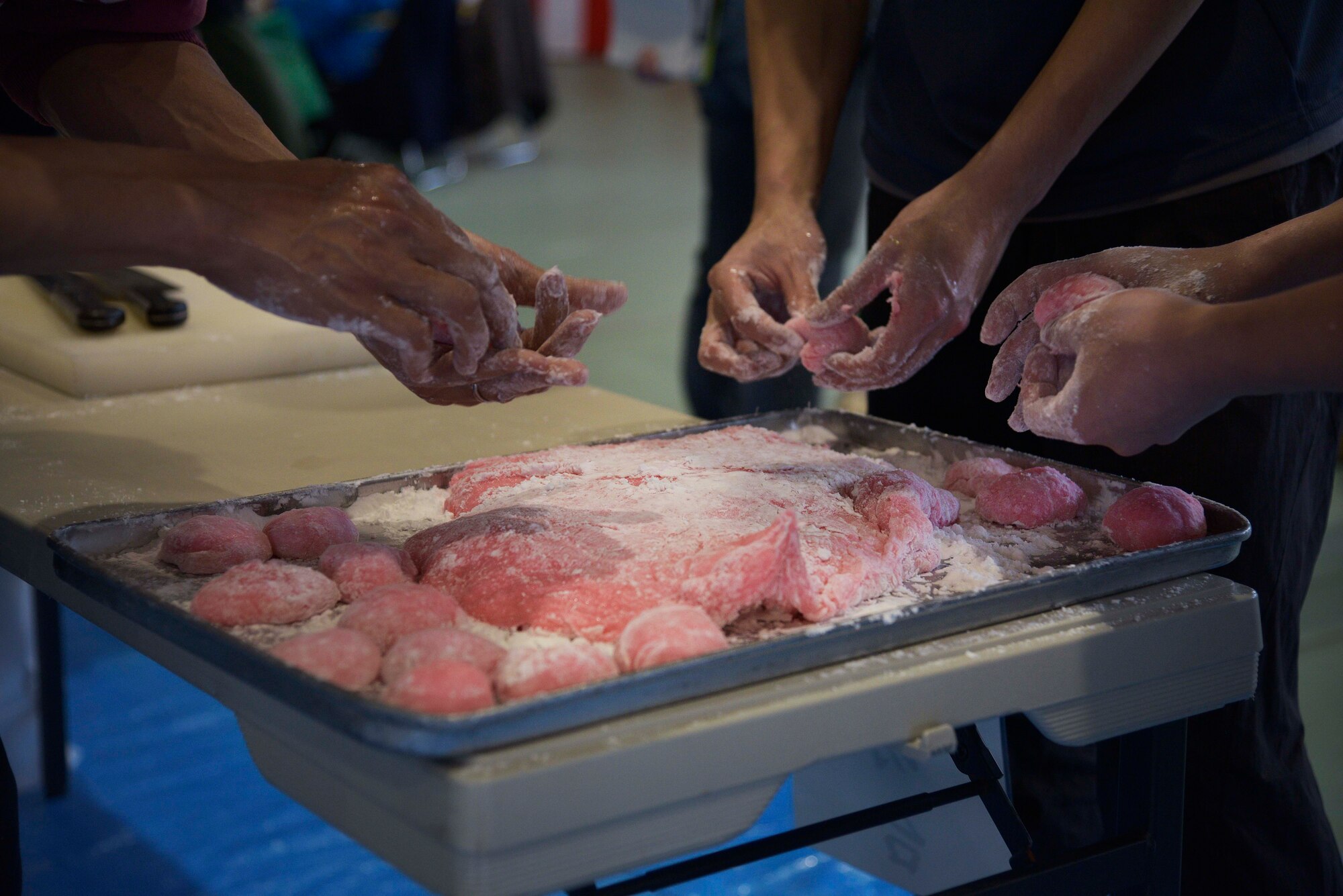 Japan Air Self-Defense Force volunteers mold mochi into balls during the annual Mochi Pounding Ceremony at Misawa Air Base, Japan, Dec. 15, 2015. After the mochi is made, it is traditionally eaten in a soup called “zoni” and paired with fish and vegetables or in a sweet red-bean soup. (U.S. Air Force photo by Senior Airman Deana Heitzman/Released)