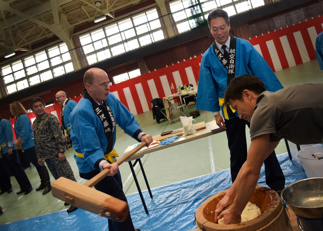 U.S. Air Force Col. Christopher Parrish, 35th Mission Support Group commander, swings a mallet during the Mochi Pounding Ceremony at Misawa Air Base, Japan, Dec. 15, 2015. The ceremony is held annually to give members of the 35th Fighter Wing and Naval Air Facility Misawa a chance to experience a Japanese New Year’s tradition and celebrate the strong bonds between the two nations. (U.S. Air Force photo by Senior Airman Deana Heitzman/Released)
