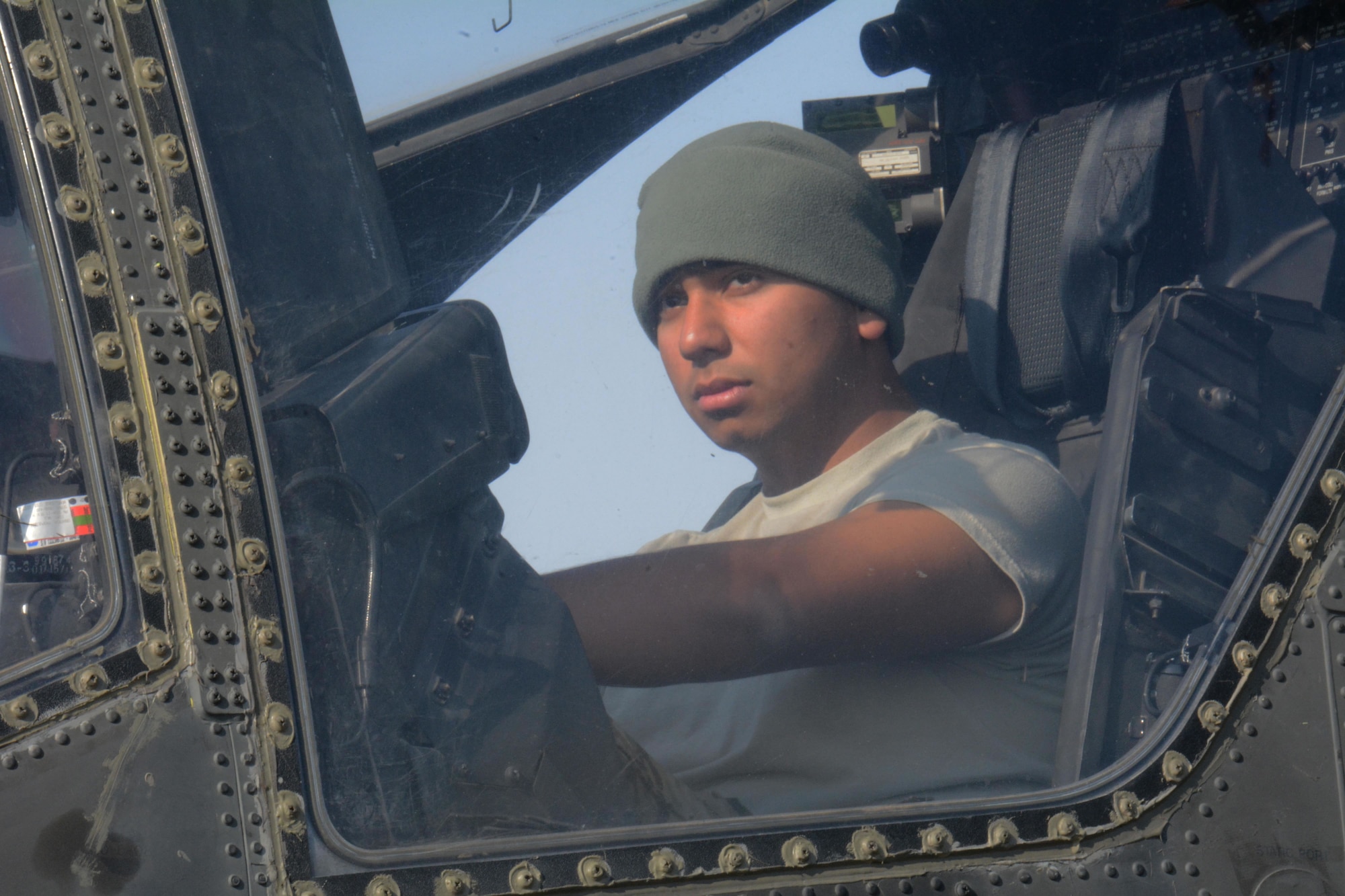 A 3-6 Heavy Cavalry Regiment soldier deployed from Fort Bliss, Texas sits inside an Apache helicopter at Al Udeid Air Base, Qatar Dec. 13. Two Apache helicopters were delivered to AUAB by a C-17 Globemaster III, which is deployed from the 62nd Airlift Wing at Joint Base Lewis-McChord, Washington. The helicopters are scheduled to take part in the annual Qatar National Day Parade set for Dec. 18. (U.S. Air Force photo by Tech. Sgt. James Hodgman/Released)