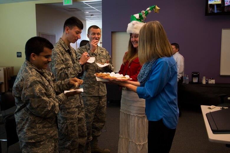 Ellicott School District teachers share cookies and goodies with Team Schriever members Monday, Dec. 14, 2015, to Ellicott, Colorado. The Schriever members delivered gifts to Ellicott as part of the Angel Tree program, an annual event hosted by the 50th Space Wing Chapel Office. (U.S. Air Force photo/Tech. Sgt. Julius Delos Reyes)