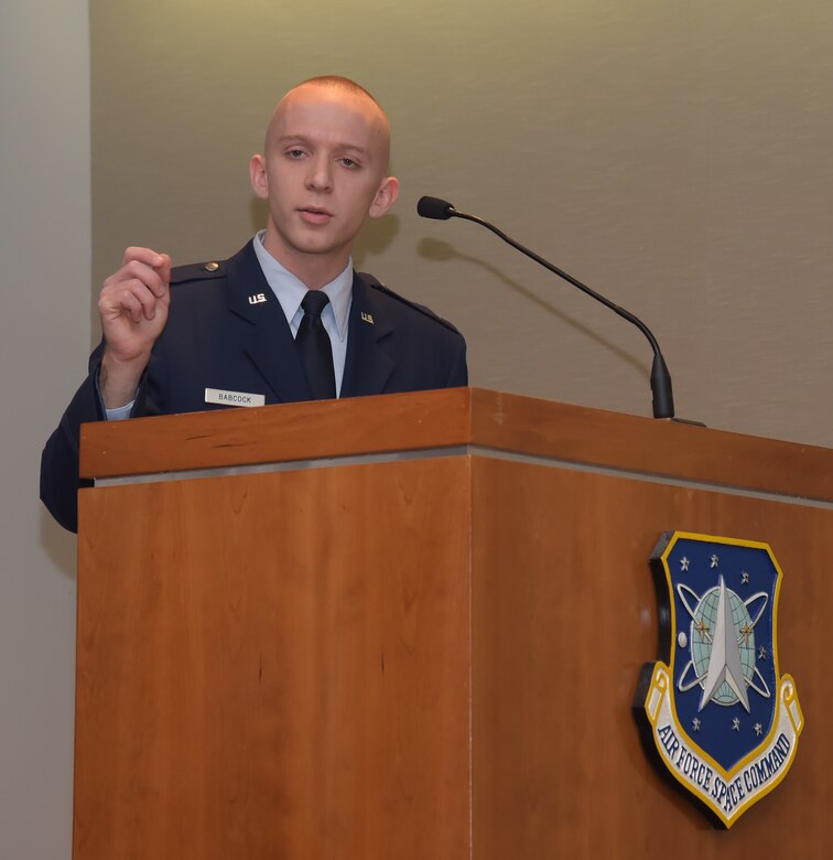 First Lt. Christopher Babcock, 50th Space Communications Squadron, gives a synopsis of his first place essay Thursday, Dec. 10, 2015, at Peterson Air Force Base, Colorado. Babcock, who wrote an essay entitled “Preparing for the Cyber Battleground of the Future,” earned the first place award in the Gen. Bernard A. Schriever Memorial Essay Contest and also received a $1,000 award from the Lance P. Sijan Chapter of the Air Force Association.  (U.S. Air Force photo/Duncan Wood)
