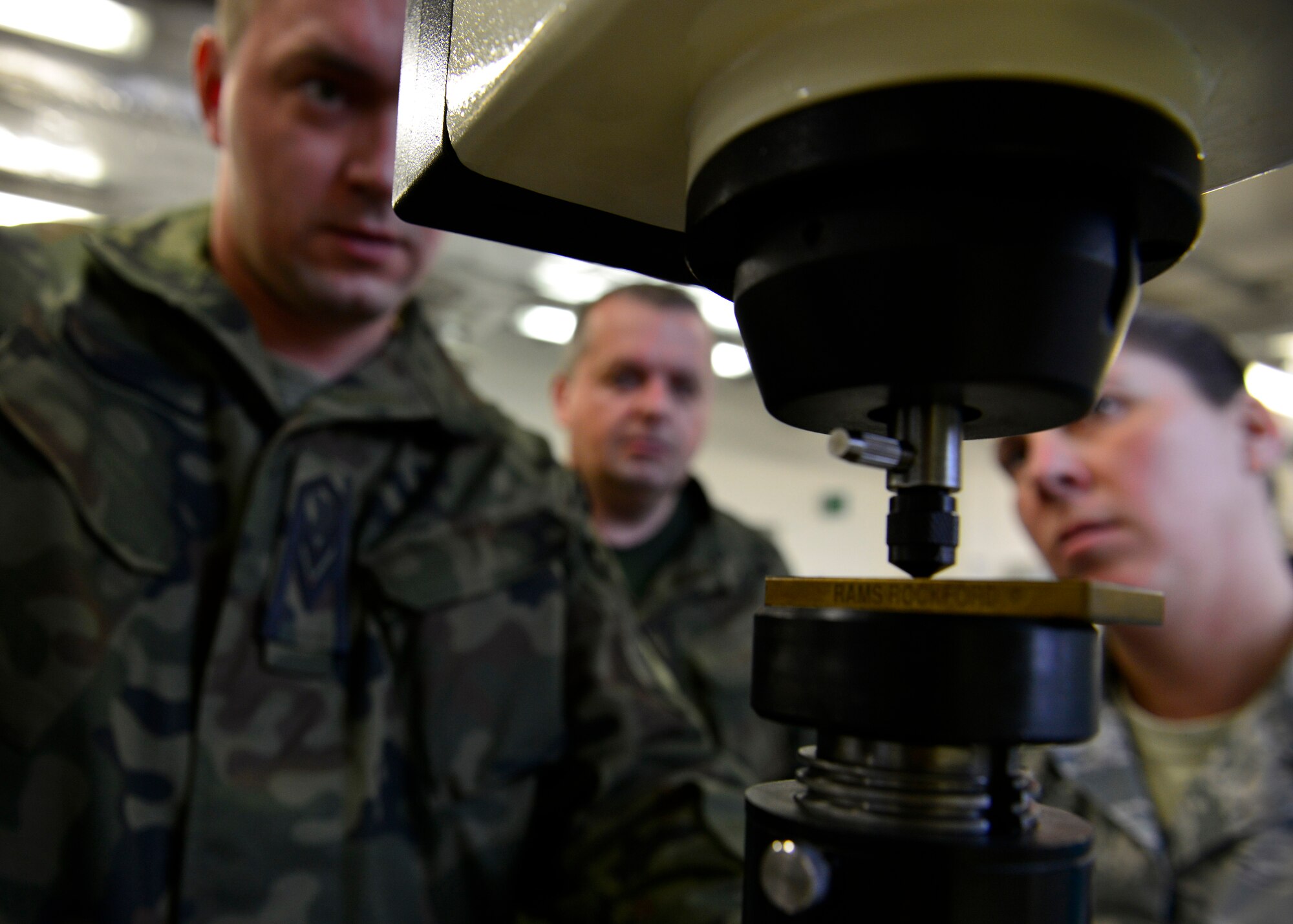 Polish and U.S. Air Force members check an aircraft part’s stress levels during a joint training event, Dec. 15, 2015, at Aviano Air Base, Italy. The training included inspection procedures, heat stress tests and aircraft part measurements. (U.S. Air Force photo by Airman 1st Class Cary Smith/Released)