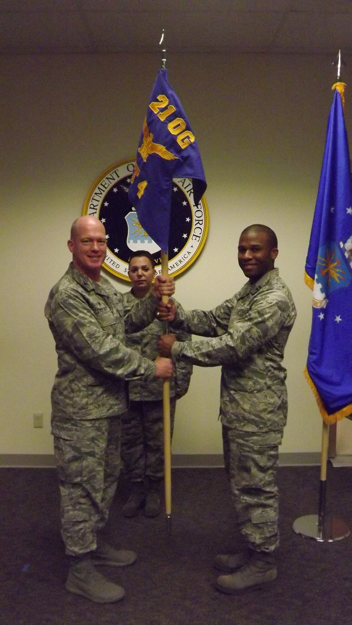 BEALE AIR FORCE BASE, Calif. – Col. Troy Endicott, 21st Operations Group commander, passes the guidon to Capt. Jonathan Brydie, 21st OG Detachment 4 commander, signifying assumption of command during a ceremony Dec. 8, 2015 at Beale Air Force Base, Calif. The 21st OG from Peterson Air Force Base, Colo. activated Detachment 4 to train Airmen and allies on upgraded early warning radar fundamentals before they are assigned to other geographically separated units of the group. (courtesy photo)