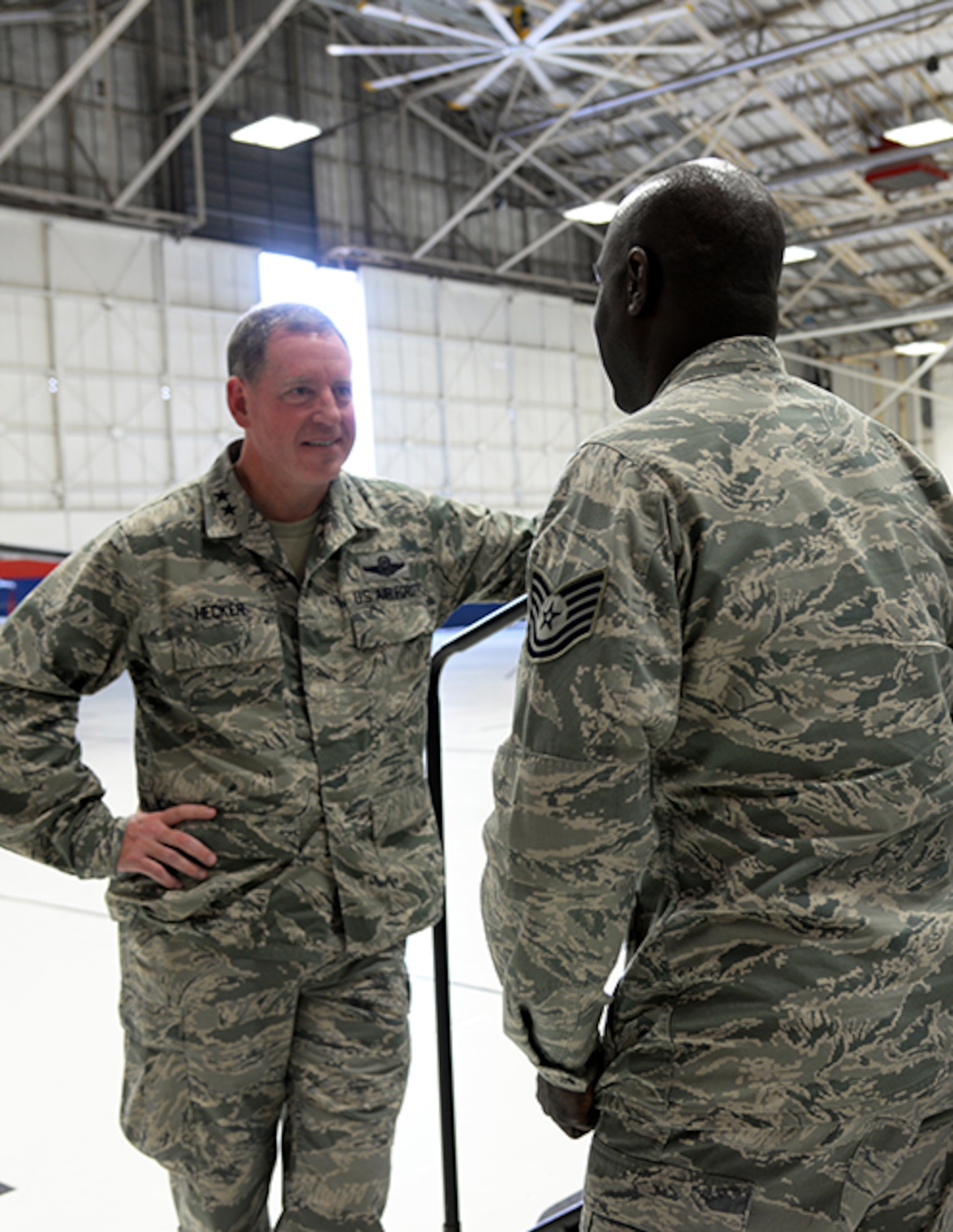 Maj. Gen. James Hecker, 19th Air Force commander, talks to Tech. Sgt. Kevin Fairman, a member of the 149th Fighter Wing, after an all call held Dec. 10 in a maintenance hangar at Joint Base San Antonio-Lackland, Texas. 