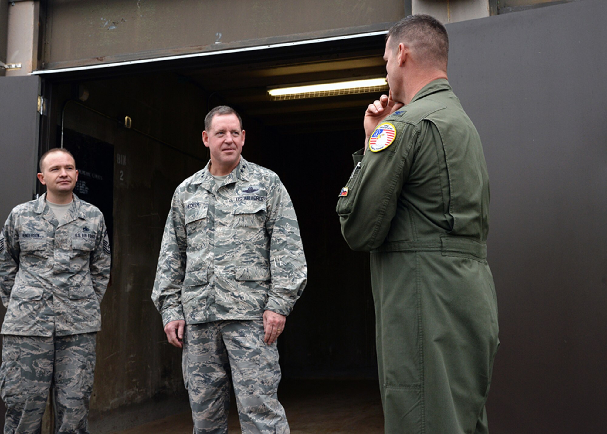 Maj. Gen. James Hecker, 19th Air Force commander, talks to Col. Bradly Glenn, Air National Guard advisor to Air Education Training Command, and Senior Master Sgt. Toby Henderson, the 149th Fighter Wing’s munitions flight chief, Dec. 10, during his visit to Joint Base San Antonio-Lackland, Texas. 

