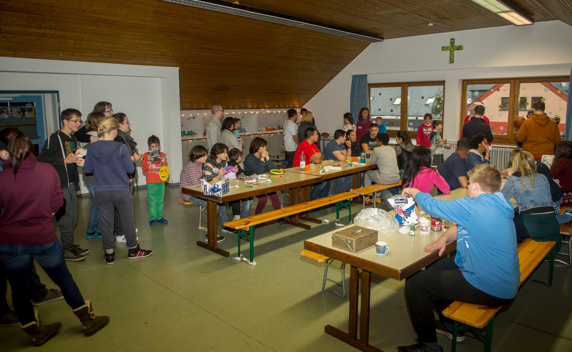 First Four volunteers from the 52nd Fighter Wing and St. Vinzenzhaus residents participate in a holiday party at the institution of child and youth services in Speicher, Germany, Dec. 13, 2015. Spangdahlem Air Base’s First Four volunteers coordinated an arts-and-craft activity booth and designed cookies with the residents. (U.S. Air Force photo by Airman 1st Class Timothy Kim/Released)