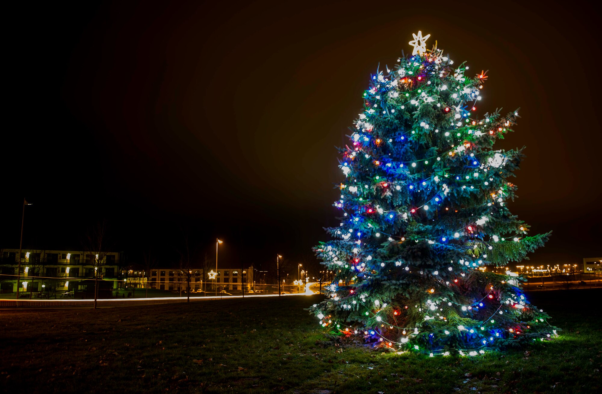 The Holiday Tree holds decorative lights after the annual tree-lighting ceremony at the Bowling Alley at Spangdahlem Air Base, Germany, Dec. 10, 2015. Participating community members observed several performances and carols, watched the tree-lighting ceremony, had an audience with Santa Claus and had free hot chocolate and cookies. (U.S. Air Force photo by Airman 1st Class Timothy Kim/Released)
