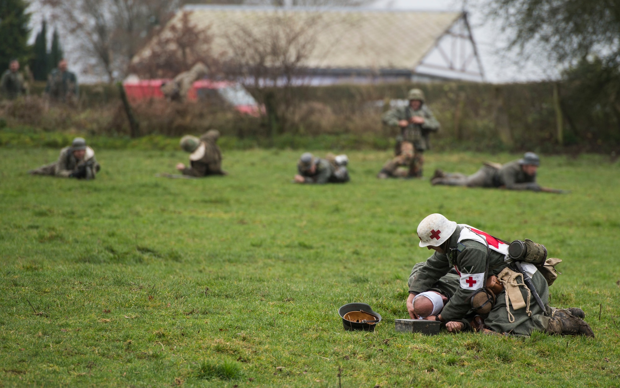 A WWII reenactment Nazi medic renders first aid to a fellow soldier during Operation Desperate Stand, Dec. 13, 2015, in Bertogne, Belgium. Over 23 million soldiers were killed during WWII from more than 24 countries who fought in the war. (U.S. Air Force photo by Staff Sgt. Christopher Ruano/Released)