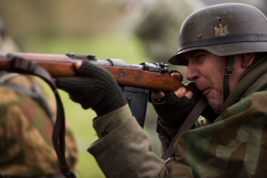 A WWII reenactment Nazi soldier engages the Allied army during Operation Desperate Stand, Dec. 13, 2015, in Bertogne, Belgium. This reenactment battle was held to commemorate the 71st anniversary of the Battle of the Bulge which began on Dec. 16, 1944. (U.S. Air Force photo by Staff Sgt. Christopher Ruano/Released)