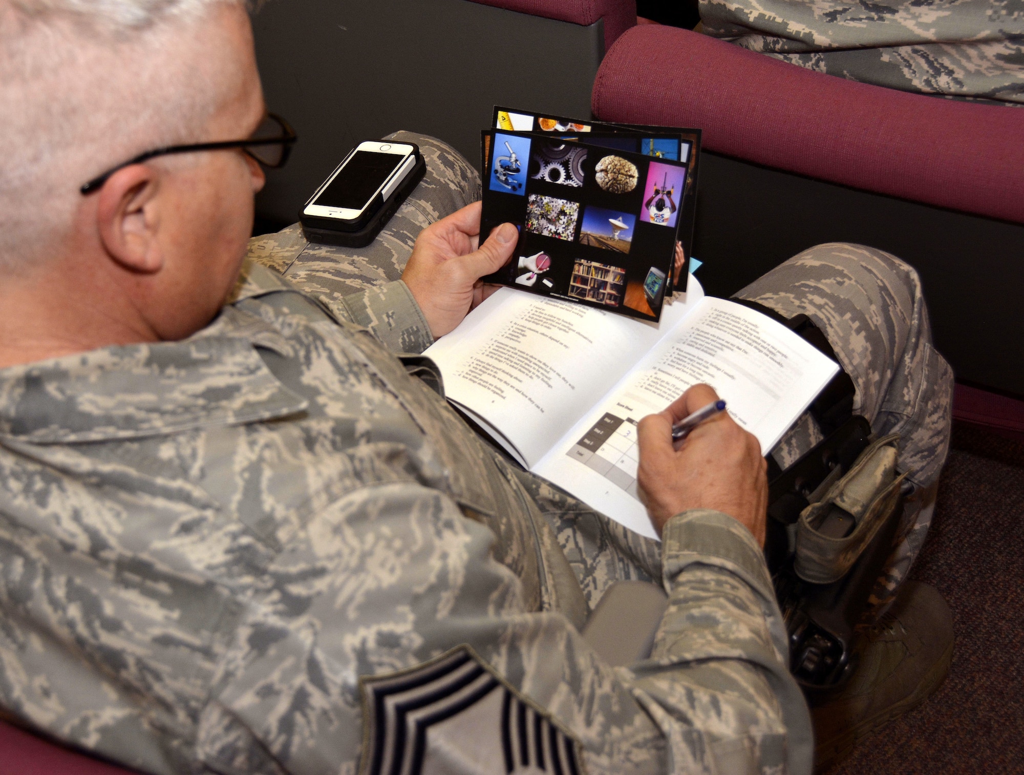 U.S. Air Force Chief Master Sgt. Brent Belcoff, manager of the 145th Security Forces Squadron, fills out his color chart during a Four Lenses & Enhanced Human Capital course held at the North Carolina Air National Guard Base, Charlotte Douglas International Airport, Dec. 11, 2015. More than 100 Airmen and Soldiers from the North Carolina National Guard attended the day-long professional development training where attendees learned better ways to communicate, not only as supervisors but strengthen communication and personal interaction with coworkers, family and friends. (U.S. Air National Guard photo by Master Sgt. Patricia F. Moran /Released)