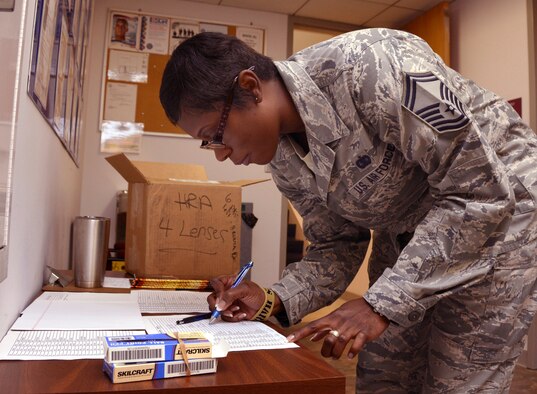 U.S. Air Force Senior Master Sgt. Martha L. Roman, 145th Airlift Wing, signs in prior to attending a Four Lenses & Enhanced Human Capital course held at the North Carolina Air National Guard Base, Charlotte Douglas International Airport, Dec. 11, 2015. More than 100 Airmen and Soldiers from the North Carolina National Guard attended the day-long professional development training where attendees learned better ways to communicate, not only as supervisors but strengthen communication and personal interaction with coworkers, family and friends. (U.S. Air National Guard photo by Master Sgt. Patricia F. Moran /Released)