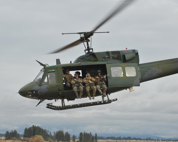 Survival Evasion Resistance and Escape Airmen from the 336th Training Group take off in a UH-1N Iroquois to practice weekly jumps to maintain their certifications and proficiency, Nov. 9, 2015 at Fairchild Air Force Base, Wash. The 36th Rescue Squadron provides the helicopter and hoist platform for a hands-on experience for both SERE specialists and combat survival students. (U.S. Air Force photo/Staff Sgt. Samantha Krolikowski)