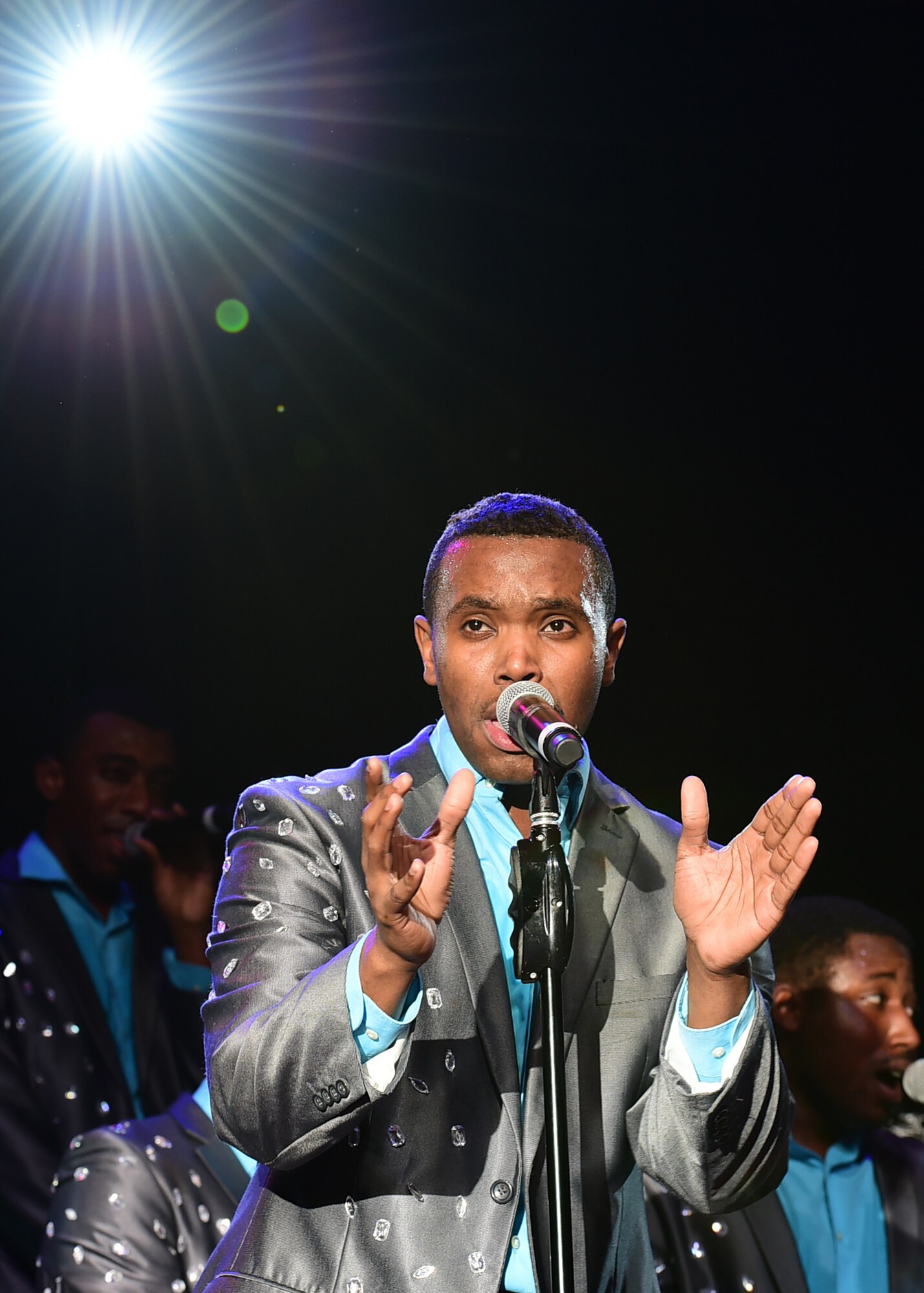 Tops in Blue vocalist Senior Airman Jordan Whitehead performs during a recent visit to the 386th Air Expeditionary Wing at an undisclosed location in Southwest Asia, Dec. 16, 2015. Comprised of 40 active-duty Airmen, the expeditionary entertainment group travels worldwide to entertain military personnel and their families, raising morale and educating audiences on topics such as resiliency and social issues through musical performances.. (U.S. Air Force photo by Staff Sgt. Jerilyn Quintanilla)