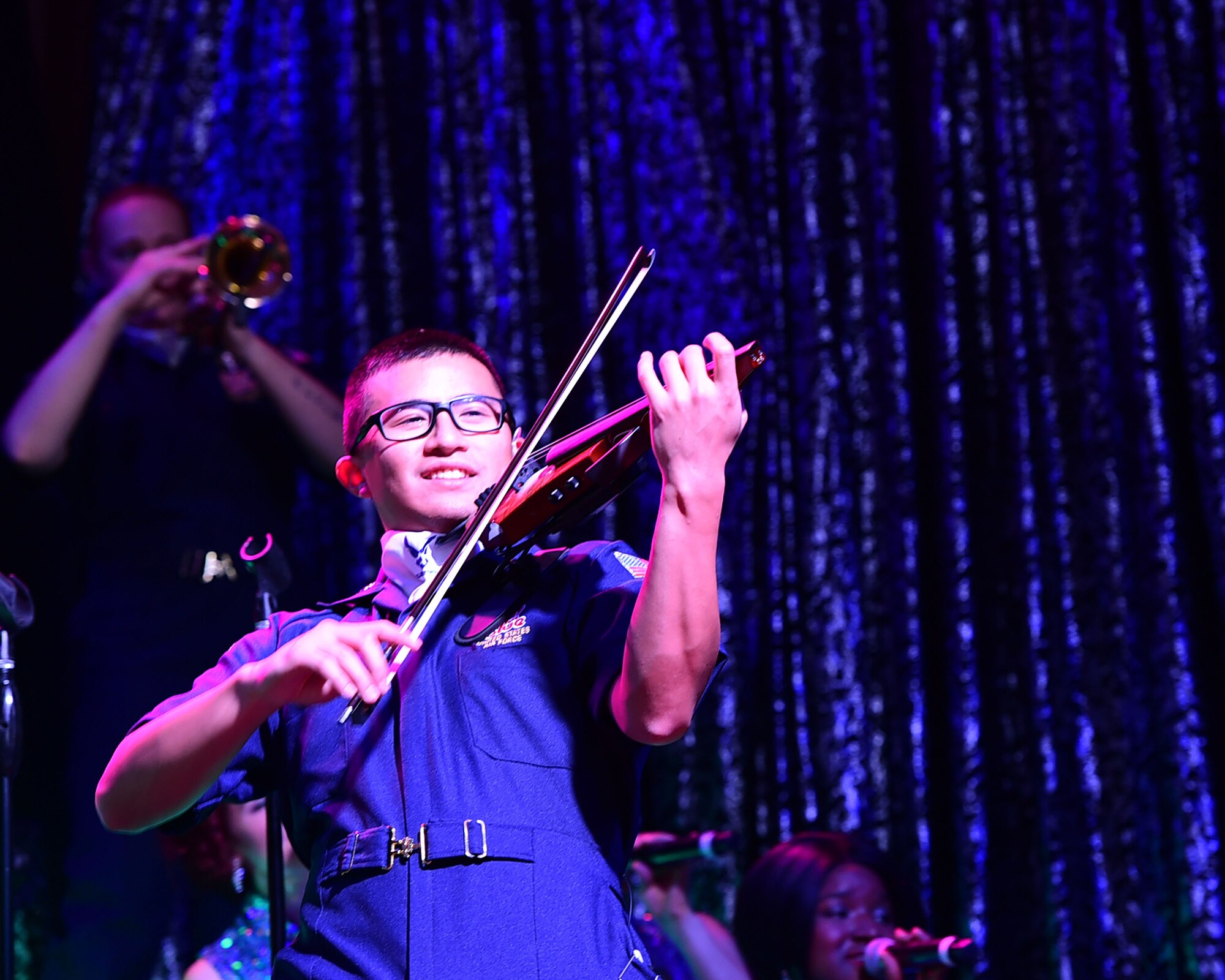 Tops in Blue violinist 1st Lt. Oliver Chang performs during a recent visit to the 386th Air Expeditionary Wing at an undisclosed location in Southwest Asia, Dec. 16, 2015.  Tops In Blue is an all active duty USAF expeditionary entertainment group that travels worldwide to entertain military personnel and their families, raising morale and educating audiences on topics such as resiliency and social issues through musical performances.. (U.S. Air Force photo by Staff Sgt. Jerilyn Quintanilla)