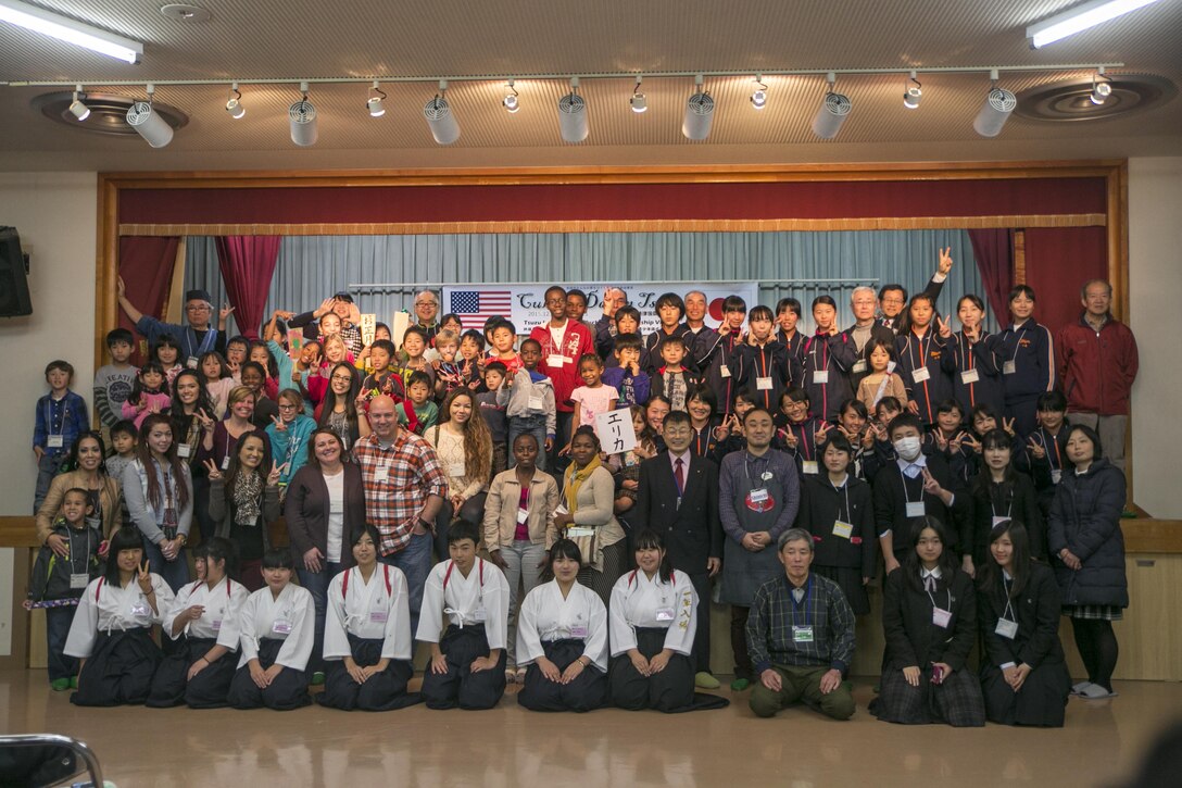 Participants pose for a group photo at the end of Cultural Day in Tsuzu, Japan, Dec. 12, 2015. The event provides both the American and Japanese communities an opportunity to interact, learn about each other’s culture, and make new friends through games, food, and arts and crafts. Visitors participated in a variety of activities such as mochi pounding, making wooden flutes, walking on bamboo stilts, and much more.