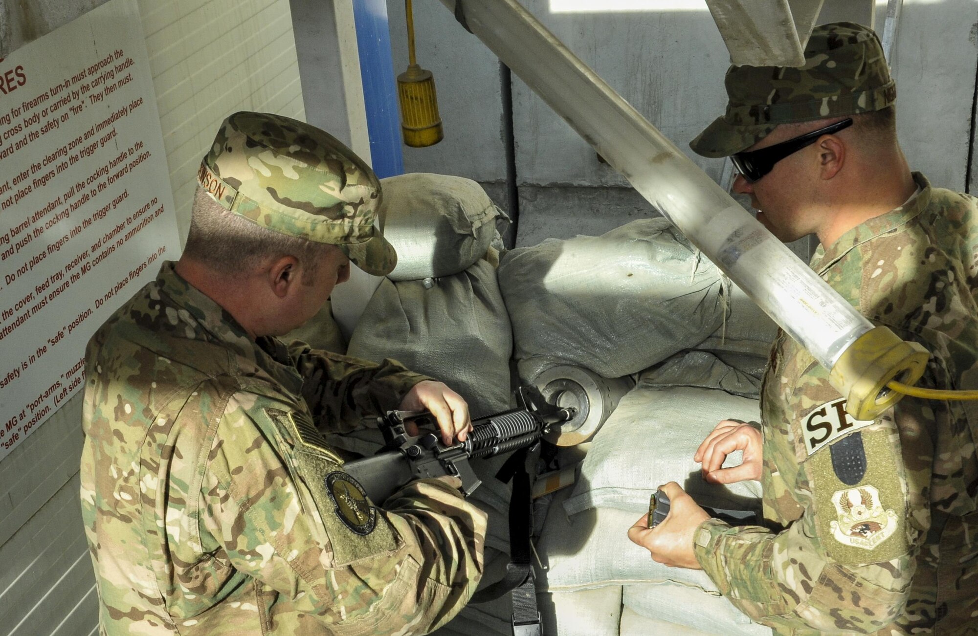 Tech. Sgt. Jason Nicholson, 455th Expeditionary Security Forces Squadron Check Six instructor for Afghanistan, directs Staff Sgt. Chris Dickinson, 455th Expeditionary Maintenance Squadron, to clear his weapon before the hands on portion of the Check Six class at Bagram Airfield, Afghanistan Dec. 3, 2015. Since the training was implemented two years ago, no active shooter incident involving Airmen has taken place in the Afghanistan area of responsibility.  (U.S. Air Force photo by Tech. Sgt. Nicholas Rau)
