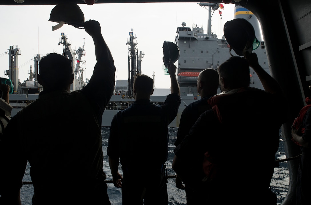 Sailors wave good-bye to the Military Sealift Command fleet replenishment oiler USNS Guadalupe after conducting a replenishment at sea with aircraft carrier USS George Washington. DLA delivered more than a million pounds of food to three South American countries for the GW to resupply during its voyage from San Diego to Norfolk, Virginia.