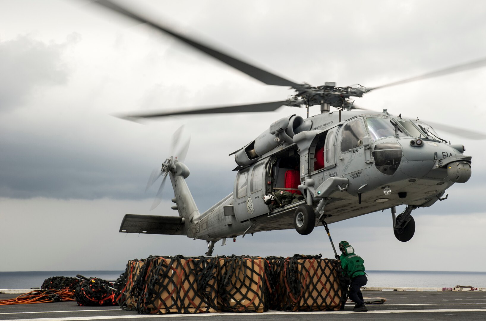 Navy logisticians attach cargo legs to an MH-60S Seahawk during a replenishment-at-sea between the Military Sealift Command fleet replenishment oiler USNS Guadalupe and aircraft carrier USS George Washington. DLA delivered more than a million pounds of food to three South American countries for the GW to resupply during its voyage from San Diego to Norfolk, Virginia.
