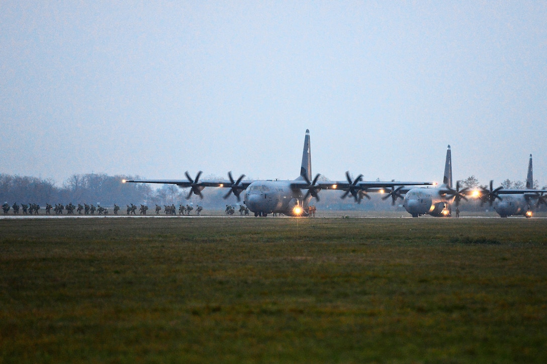 A line of U.S. Air Force C-130 Hercules aircraft prepare for takeoff after delivering paratroopers during Exercise Rock Nemesis at Rivolto Air Base, Italy, Dec. 4, 2015. The paratroopers are assigned to the 2nd Battalion, 503rd Infantry Regiment, 173rd Airborne Brigade Combat Team. The aircraft crew is assigned to the 86th Air Wing. U.S. Army photo by Paolo Bovo