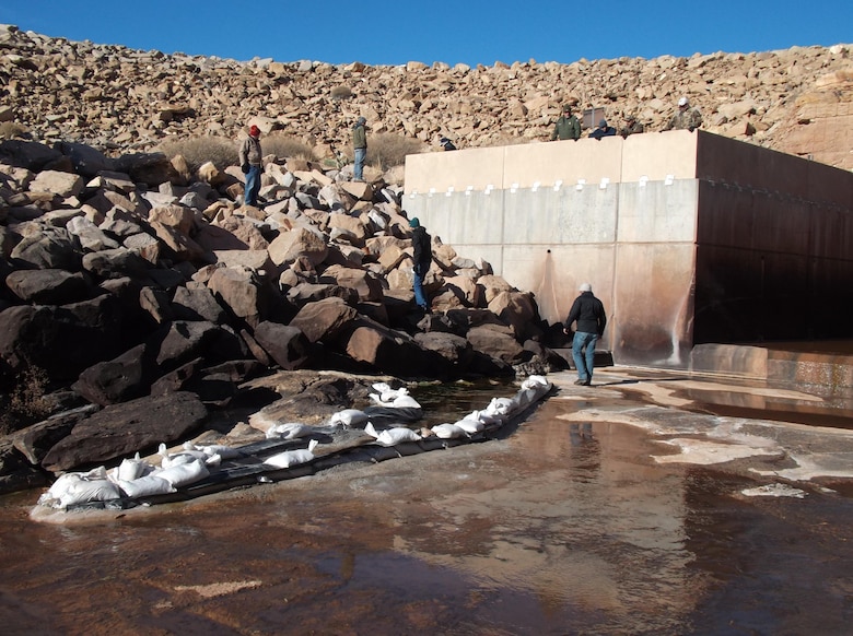 Savannah district’s risk cadre members and Risk Management Center staff inspect the Santa Rosa Dam in New Mexico for the Albuquerque District December 2013. The coalition inspected the seepage location adjacent to the dam’s spillway stilling basin during a risk assessment. 