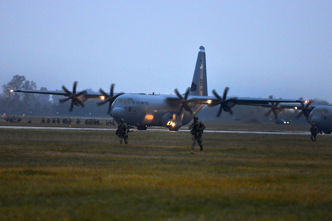 U.S. Army paratroopers participate in a follow-on mission after exiting U.S. Air Force C-130 Hercules aircraft during Exercise Rock Nemesis at Rivolto Air Base, Italy, Dec. 4, 2015. U.S. Army photo by Paolo Bovo