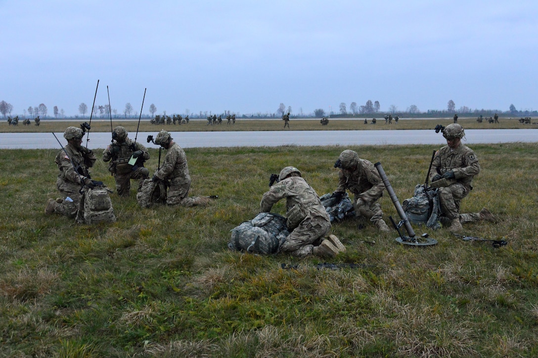 U.S. soldiers conduct a radio check during Exercise Rock Nemesis at Rivolto Air Base, Italy, Dec. 4, 2015. U.S. Army photo by Paolo Bovo