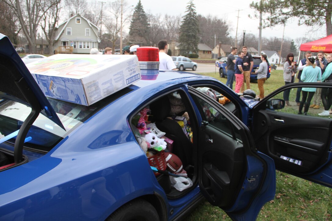 The United States Marine Corps recruiters from Recruiting Sub-Station Kalamazoo, Mich., joined Michigan State Troopers in a toy drive, hosted by a Western Michigan University frat and sorority, Dec. 12, 2015. The purpose of the drive was to fill a Michigan State Trooper patrol car with toys and canned foods to be distributed to families in need for the Christmas holiday season. More than 300 brand-new toys and 100 canned foods were collected.