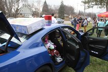 The United States Marine Corps recruiters from Recruiting Sub-Station Kalamazoo, Mich., joined Michigan State Troopers in a toy drive, hosted by a Western Michigan University frat and sorority, Dec. 12, 2015. The purpose of the drive was to fill a Michigan State Trooper patrol car with toys and canned foods to be distributed to families in need for the Christmas holiday season. More than 300 brand-new toys and 100 canned foods were collected.