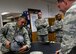 Tech. Sgt. Louis Soriano, a member of the 149th Operations Group, shows Maj. Gen. James Hecker, 19th Air Force commander, the capabilities of a pilot's helmet mounted with integrated targeting technology at the aircrew flight equipment section during the general's visit to Joint Base San Antonio-Lackland, Texas, Dec. 10.