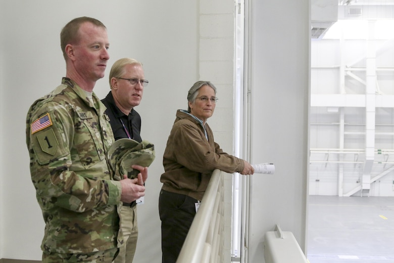 Troy Morris (center), project manager, briefs Col. Kirk Gibbs, commander of the U.S. Army Corps of Engineers Los Angeles District, at Davis-Monthan Air Force Base, Arizona, Dec. 7. Morris guided Gibbs and Shari Brandt, resident engineer for the Tucson Resident Office, through the newly completed 309th Aerospace Maintenance and Regeneration Group hangar, a 76,746-square-foot facility that features a two-story administration section housing a technical order library, records storage, tool cribs, equipment storage and an observation deck overlooking the hangar floor.