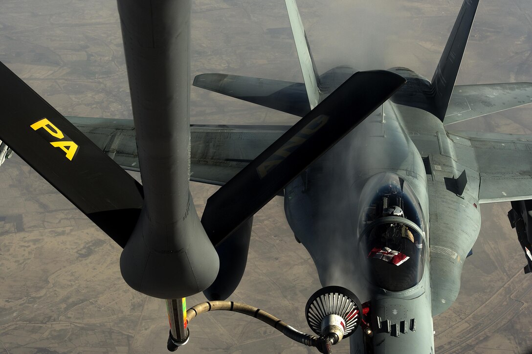 An U.S. Air Force KC-135 Stratotanker refuels a F-18 aircraft from the Canadian air force in support of Operation Inherent Resolve over Southwest Asia, Dec. 4, 2015. U.S. Air Force photo by Tech. Sgt. Nathan Lipscomb