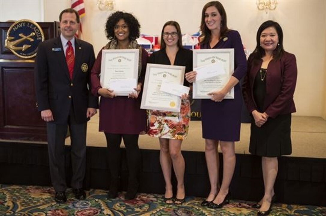 The 2015 San Diego Sea Service Coast Guard, Marine Corps and Navy Spouses of the Year recipients Cutter Boutwell, Amanda McMillan and Candace McVey pose with the council president and vice president of the San Diego Council Navy League of the United States after being awarded at the SDCNL monthly luncheon in San Diego, Dec. 4. Nominees were selected by their respective commands for exhibiting a balance in their military community, their work and home life, and for serving their local community.