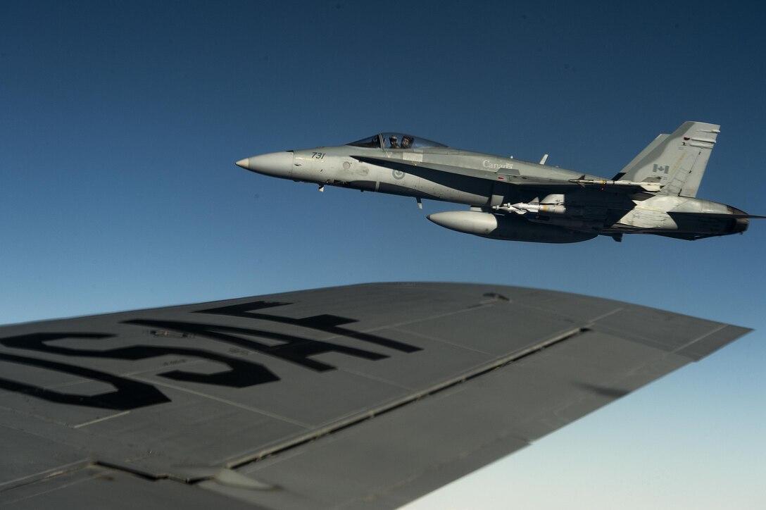 An F-18 Canadian air force aircraft flies next to a U.S. Air Force KC-135 Stratotanker in support of Operation Inherent Resolve over Southwest Asia, Dec. 4, 2015. U.S. Air Force photo by Tech. Sgt. Nathan Lipscomb