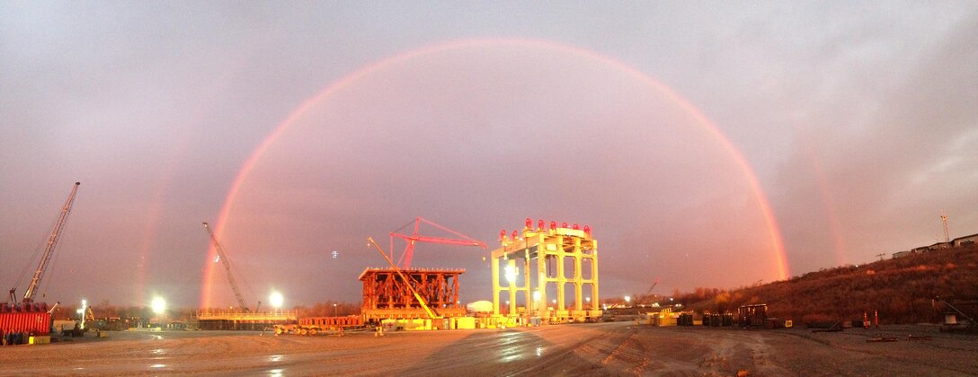 A rainbow appears over the super gantry crane as the sun rises at the Olmsted Dam construction project on the lower Ohio River. 