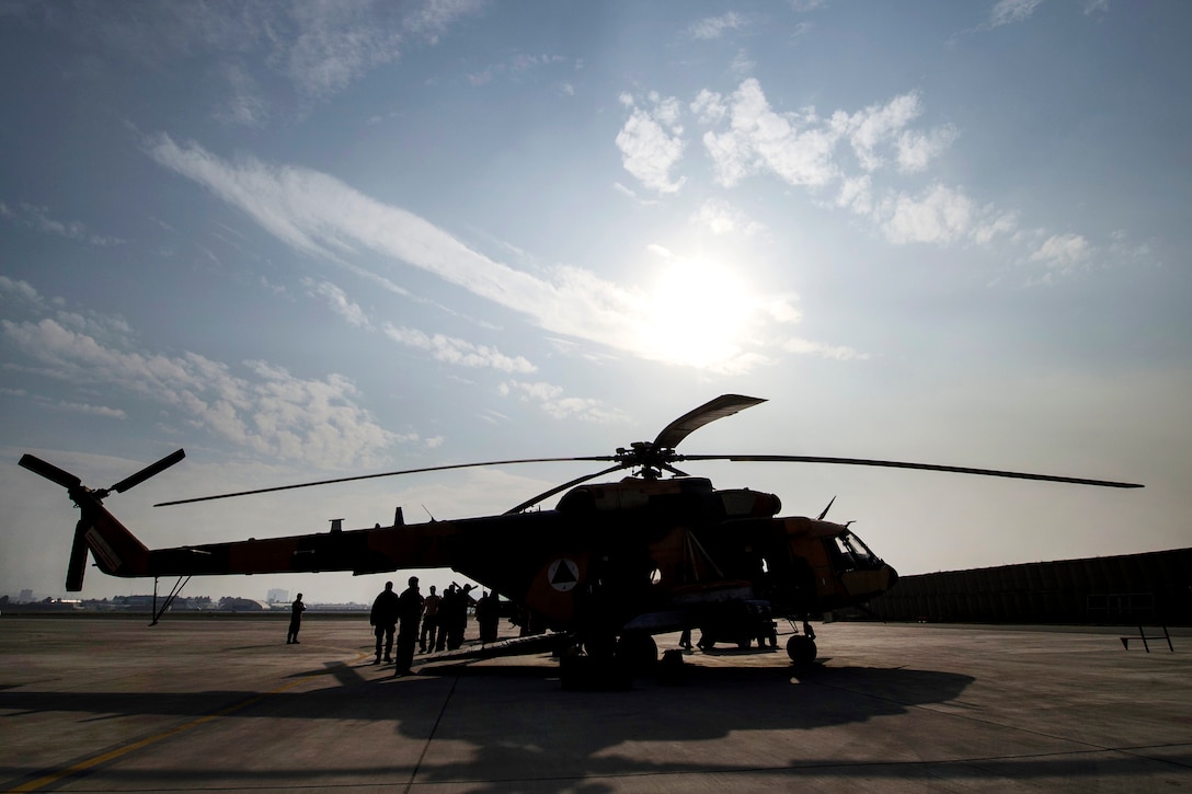An Afghan air force Mi-17 helicopter sits on the flight line before an aerial training mission with U.S. soldiers on Hamid Karzai International Airport, Kabul, Afghanistan, Dec. 7, 2015. The Mi-17 is a mature weapon system that is the backbone of the Afghan air force. U.S. Air Force photo by Staff Sgt. Corey Hook