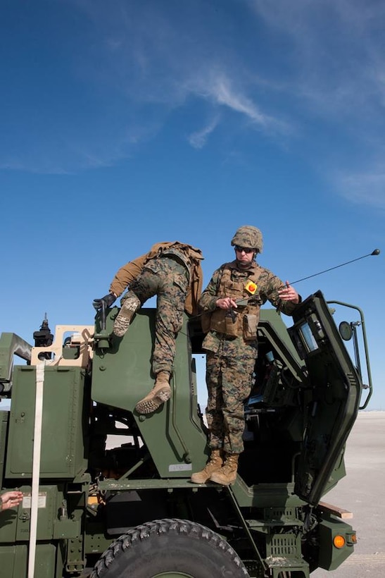 High Mobility Artillery Rocket System (HIMARS) crewmen assigned to Battery D, 2nd Battalion, 14th Marine Regiment, prepare their launcher for live-fire operations after debarking a KC-130J aircraft, supporting their raid operations at White Sands Missile Range, New Mexico, Dec. 4, 2015.