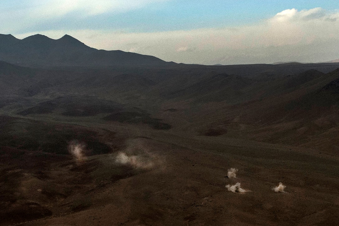 Rockets explode after hitting the ground on a closed-off weapons testing range after being fired from the rocket pod on board an Afghan air force Mi-17 helicopter near Kabul, Afghanistan, Dec. 7, 2015. U.S. Air Force photo by Staff Sgt. Corey Hook