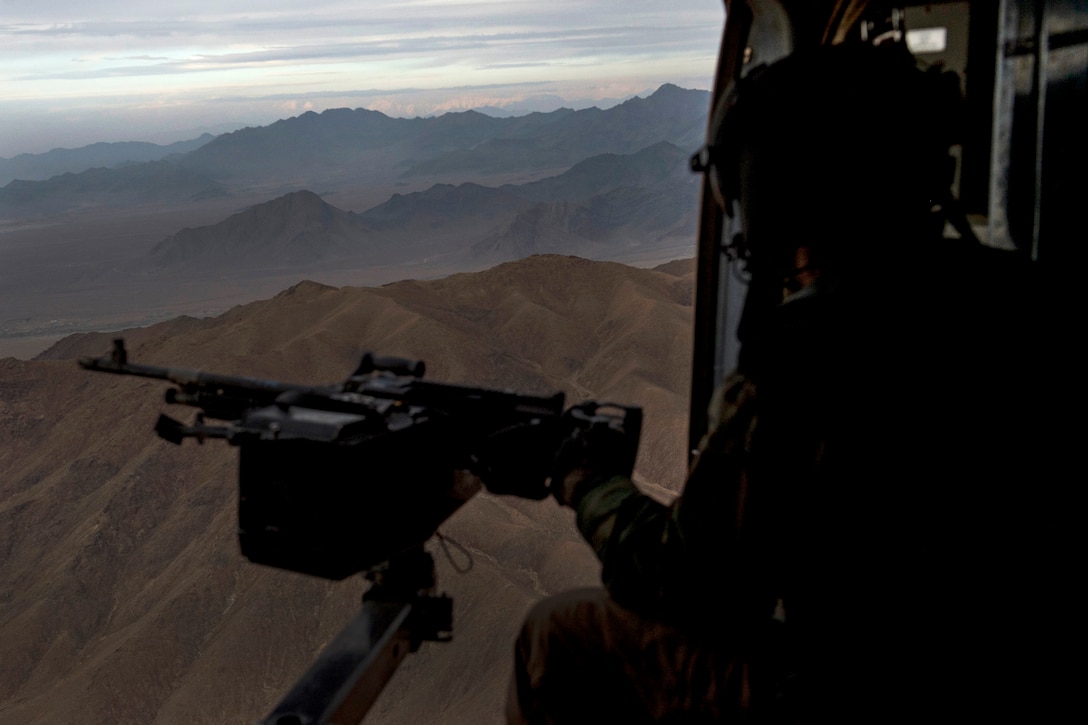 An Afghan air force aerial gunner flies on an Afghan air force Mi-17 helicopter near Kabul, Afghanistan, Dec. 7, 2015. The Mi-17 is equipped with two M-240 machine guns. U.S. Air Force photo by Staff Sgt. Corey Hook