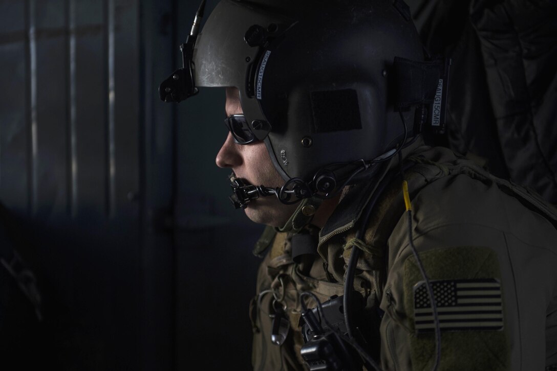 U.S. Air Force Tech. Sgt. Tim Chase flies aboard an Afghan air force Mi-17 helicopter near Kabul, Afghanistan, Dec. 7, 2015. Chase is a flight engineer assigned to the Train, Advise, Assist Command-Air. U.S. Air Force photo by Staff Sgt. Corey Hook