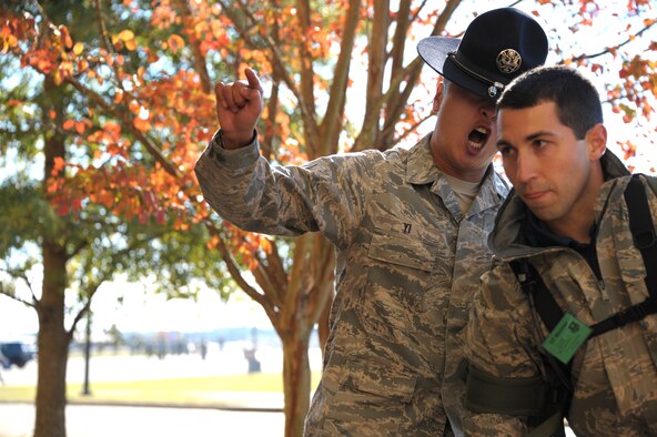 Tech. Sgt. Chi Yi welcomes new an officer trainee to Officer Training School Nov. 13, 2013, at Maxwell Air Force Base, Ala. Yi and his fellow military training instructors will instill basic military knowledge during the OTs time here. (U.S. Air Force photo/Airman 1st Class William Blankenship) 
