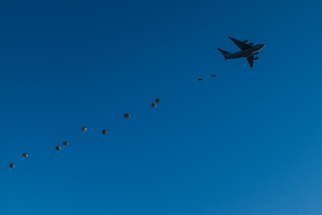 Army paratroopers exit a C-17 Globemaster III aircraft during the Randy Oler Memorial Operation Toy Drop over Sicily drop zone on Fort Bragg, N.C., Dec. 5, 2015. U.S. Army photo by Timothy L. Hale