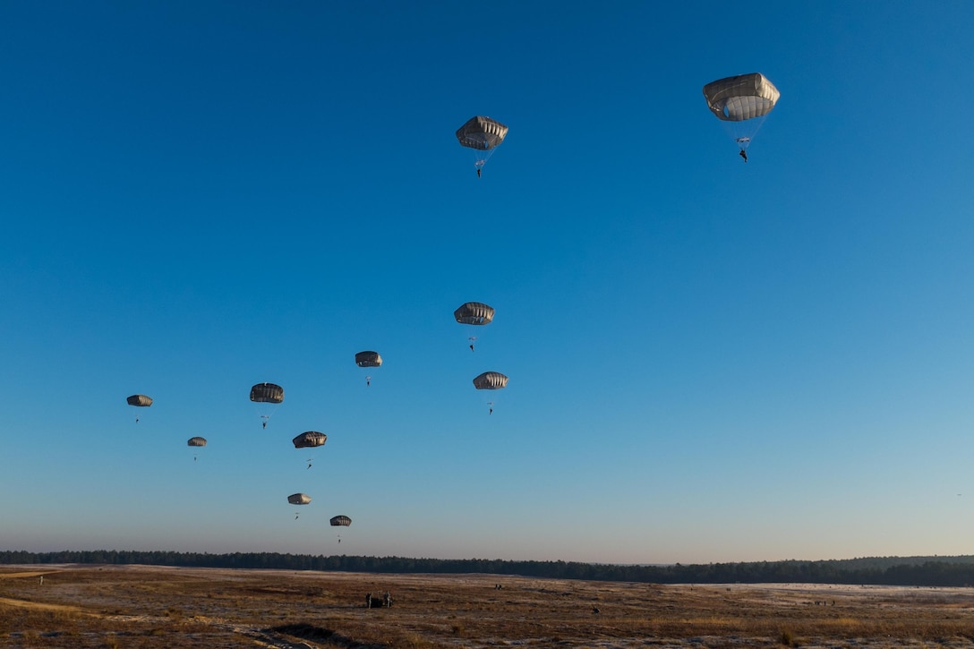 Army paratroopers fill the sky during the Randy Oler Memorial Operation Toy Drop over Sicily drop zone on Fort Bragg, N.C., Dec. 5, 2015. U.S. Army photo by Timothy L. Hale