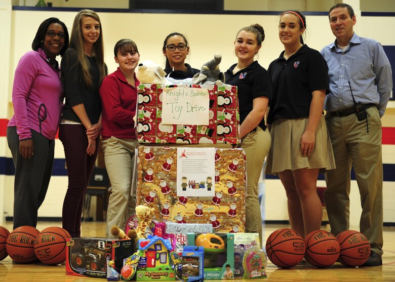 Members of the Faith Christian School’s women’s varsity basketball team pose in their gym in Summerville, South Carolina, for a photo displaying gifts received from a toy drive Dec. 17, 2015. The team’s coach, Nichelle Cunningham, master sergeant with the 315th Airlift Wing Judge Advocate, coordinated the donation, which was student inspired. These toys will go to service members’ families who are in need during the Christmas season by way of the 315th AW Family and Airman Readiness Office. (U.S. Air Force photo by Senior Airman Jonathan Lane)