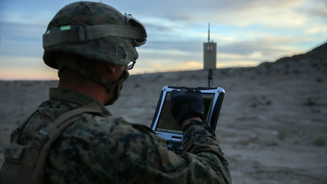 Lance Cpl. Travis DeShazo, a rifleman assigned to Company E, 2nd Battalion, 4th Marine Regiment, 1st Marine Division, prepares a computer to control a Raven unmanned aerial system to establish the location of notional enemy units aboard Marine Corps Air Ground Combat Center, California, Dec. 10, 2015. The Marines employed the Raven UAS as part of Steel Knight to gain a better understanding of it and develop a higher proficiency of what it takes to operate as a more effective as the ground combat element of the I Marine Expeditionary Force. 