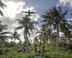 Islanders watch a C-130 Hercules fly overhead during Operation Christmas Drop 2015 at Fais Island, Federated States of Micronesia, Dec. 8, 2015. A C-130 assigned to the 36th Airlift Squadron delivered over 800 pounds of supplies to the island during the operation. This year marked the first ever trilateral Operation Christmas Drop where the Air Force, Japan Air Self-Defense Force and the Royal Australian Air Force worked together to provide critical supplies to 56 Micronesian islands. (U.S. Air Force photo/Osakabe Yasuo)